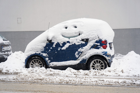 Smart Car covered with snow and with a smiley :)