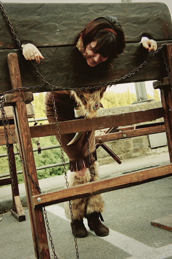 Girl locked in medieval pillory