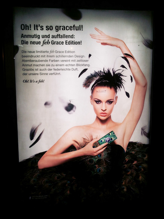 Feh Billboard: Peacocking Model with Photoshop warning. Model Anna Kuen.