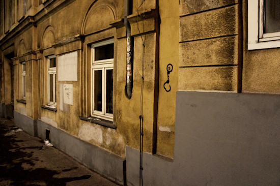 wall with hook and handcuff graffiti