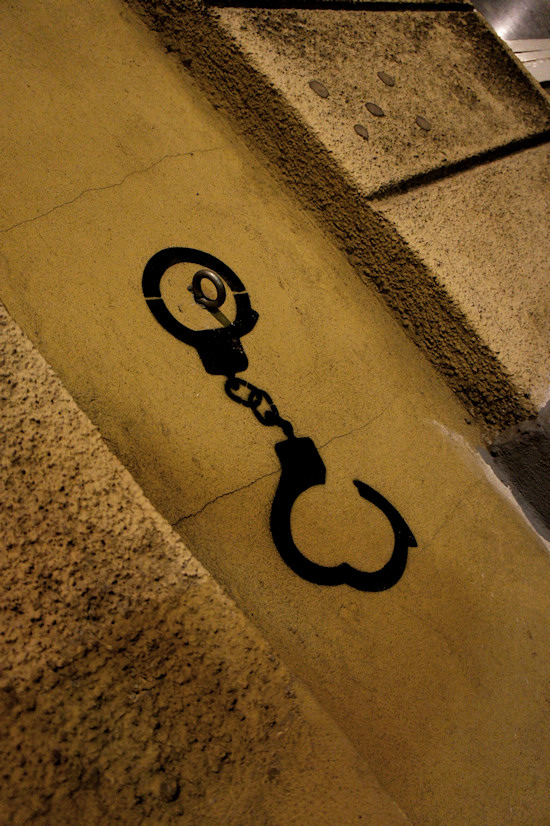 wall with hook and handcuff graffiti